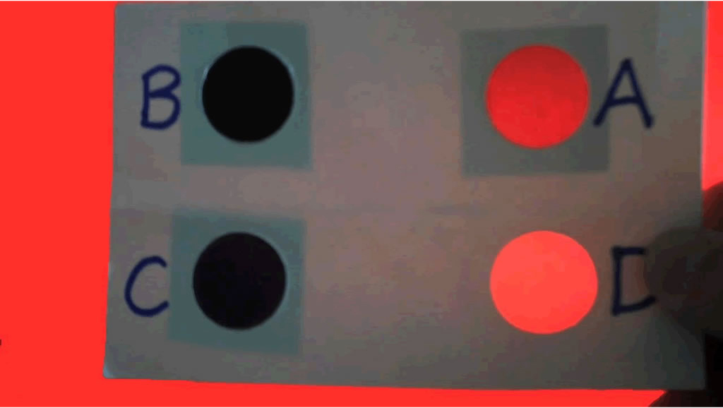 Image of color analyzer against a red background, positioned 45° from the horizon.