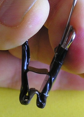 Closeup of clip for interchangeable planets. Black duct tape on the clip makes for a more secure connection to to the wire.